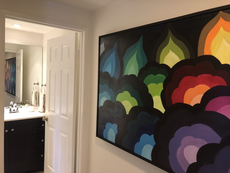 Retro artwork leading to the 3rd bathroom in the hallway.