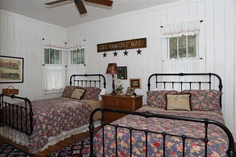 guest room with two queen rooms and a private bathroom