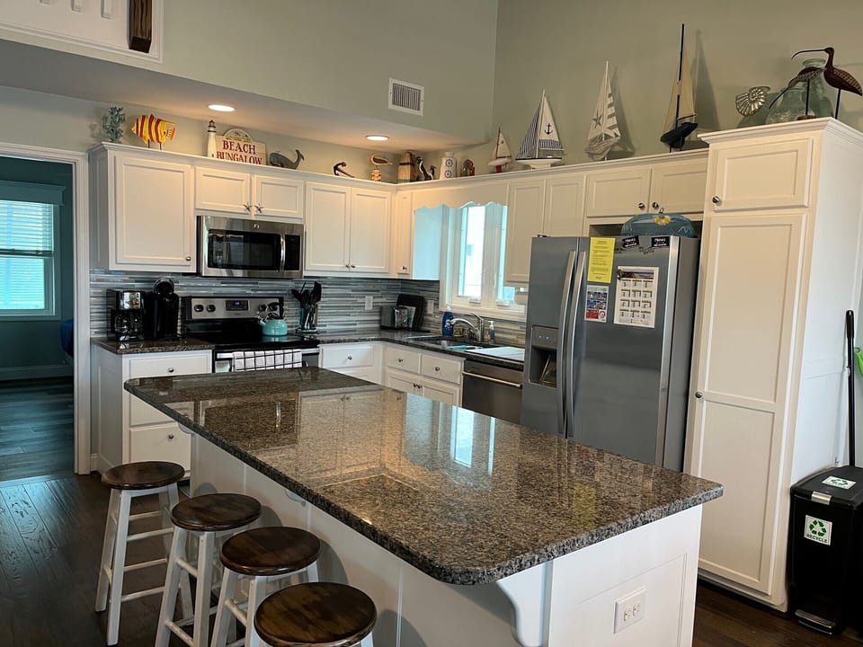 Kitchen has granite counter tops and stainless-steel appliances.
