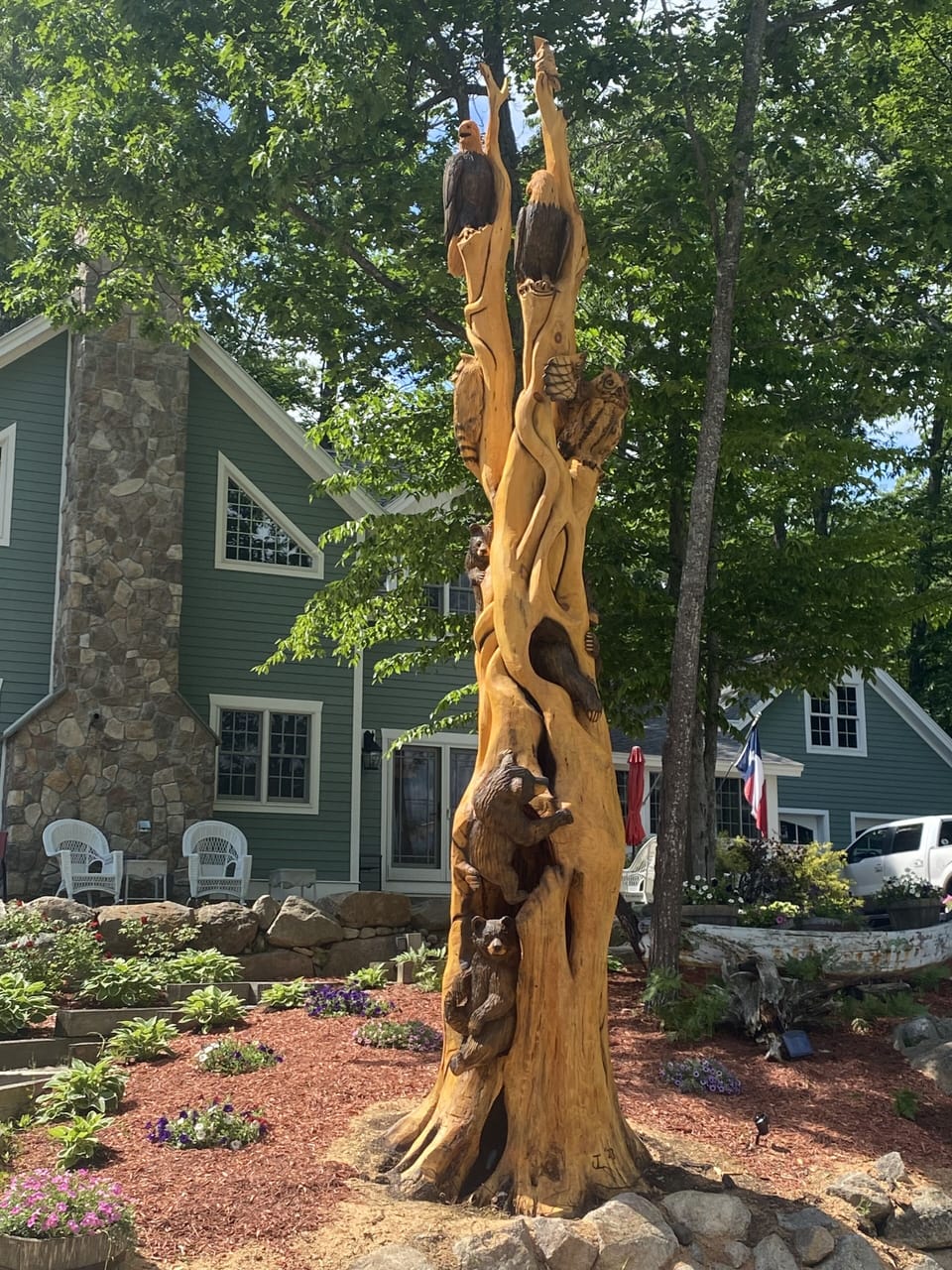 Tree carving out front of house