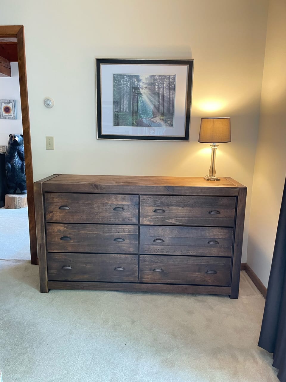 Primary bedroom dresser with view into the great room and kitchen. 