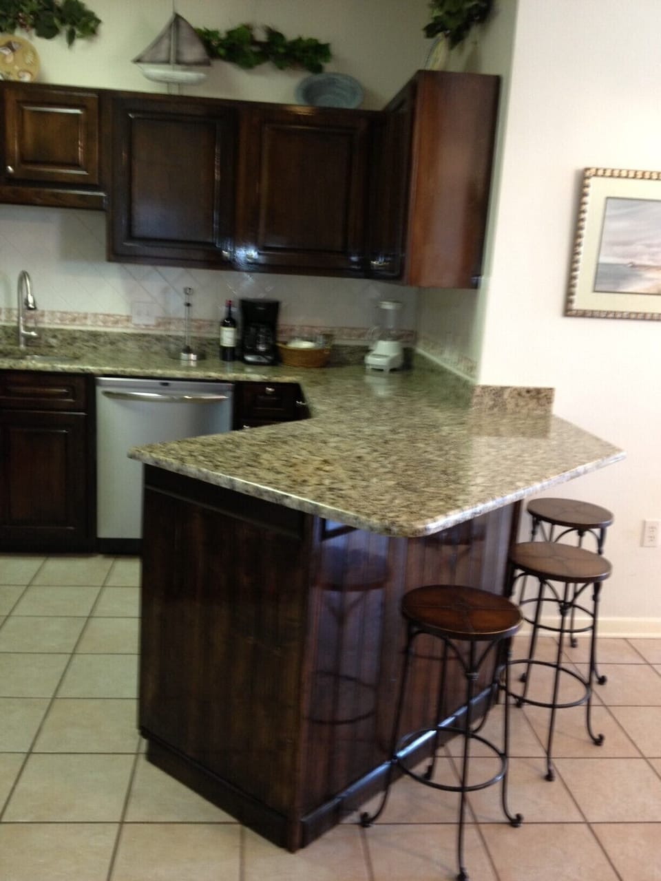 Newly remodeled kitchen with granite countertops and bar.