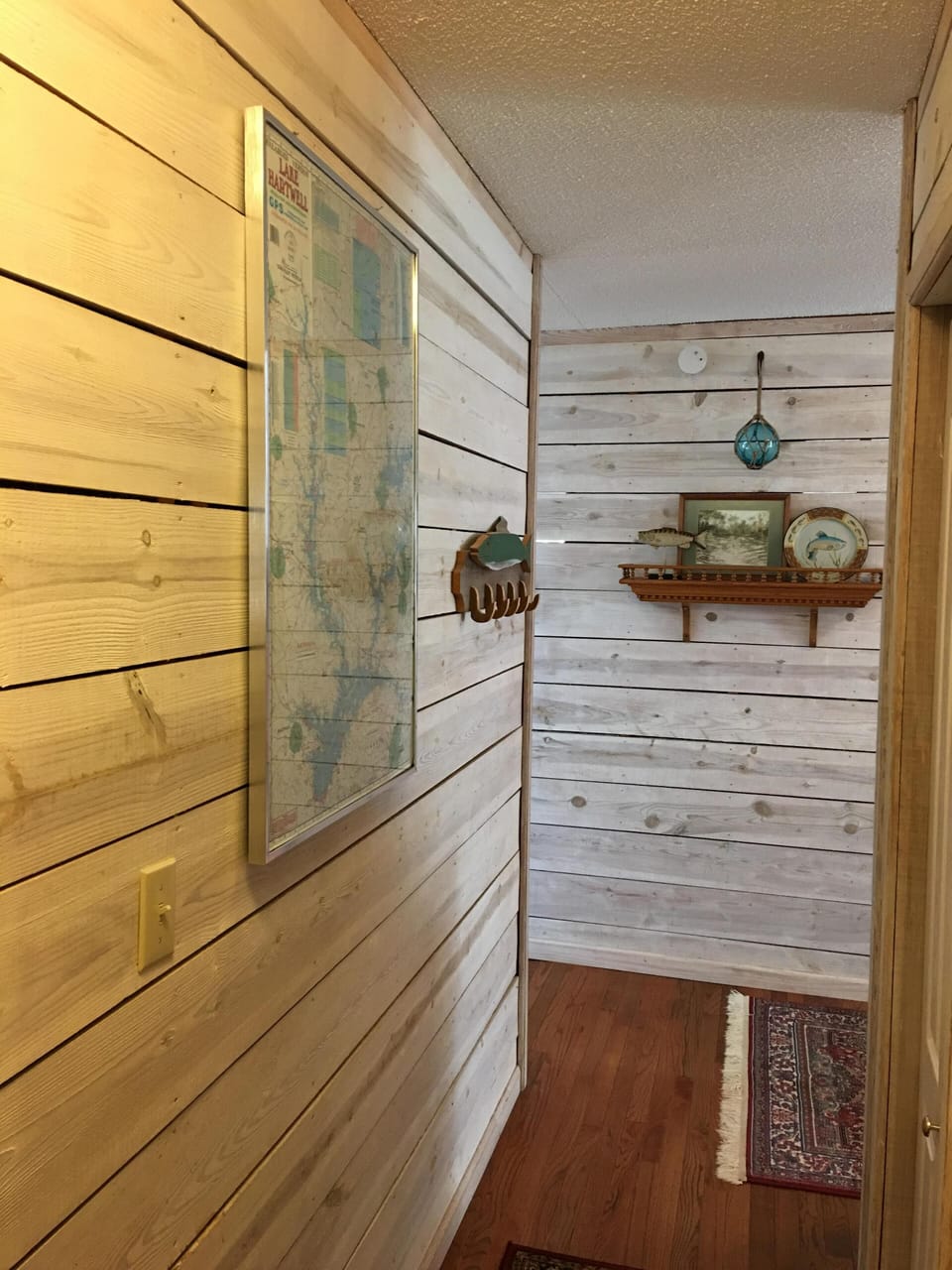 Shiplap hallway with Oriental rugs 