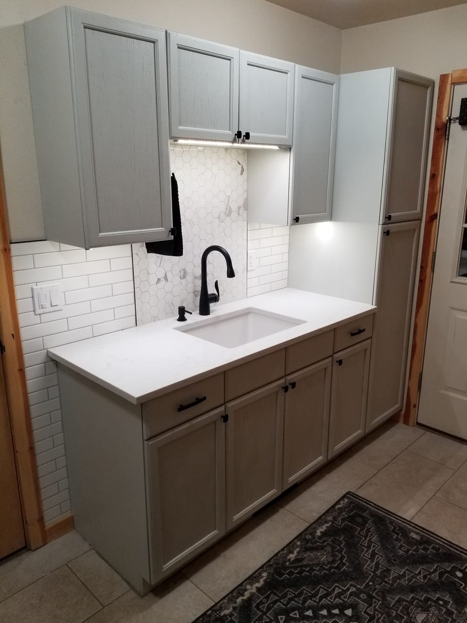 New remodeled laundry/mud room, custom tile, quartz counters, and washer/dryer. 
