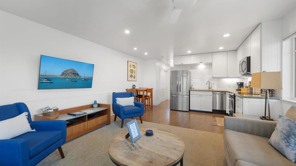 The spacious living room has a large flat-screen TV, fireplace and comfortable seating.