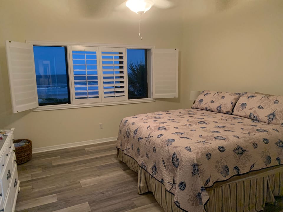 Primary bedroom overlooking the ocean with king size bed