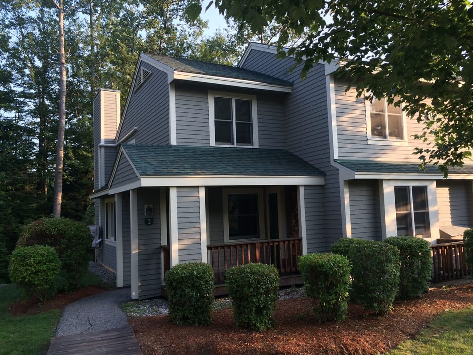 Outside view of the end unit townhome. 2 assigned parking spaces nearby.