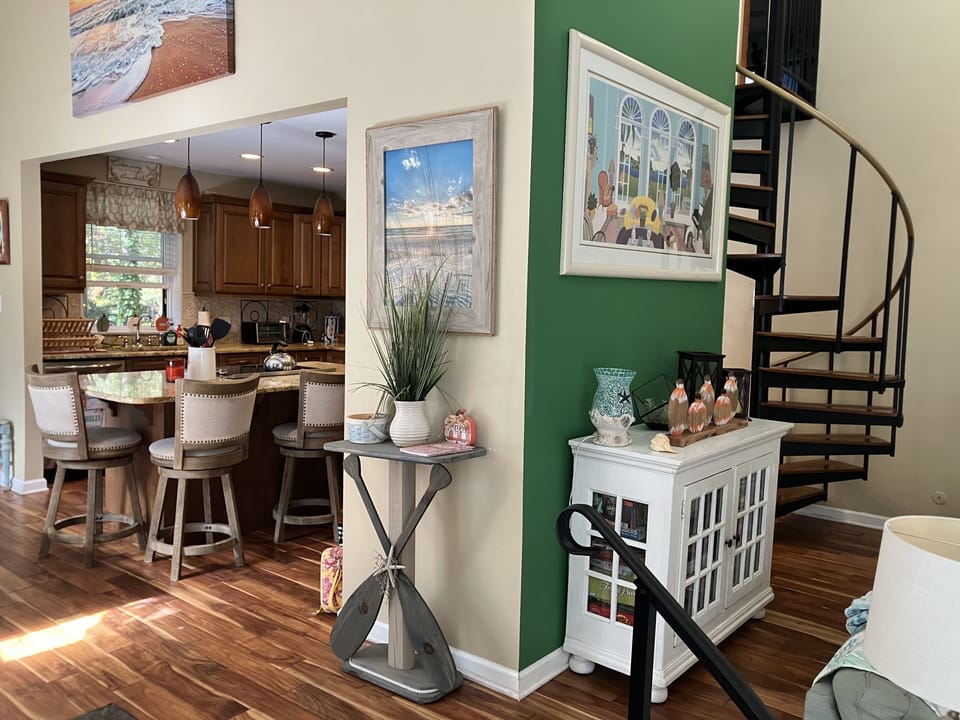 Kitchen flows to dining and living room. Spiral stairs to 2nd floor.