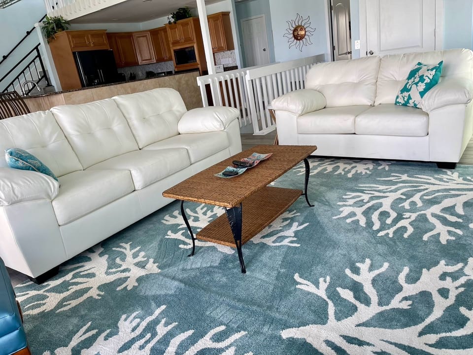 Spacious living area. Windows overlook the water. Open to kitchen & dining.