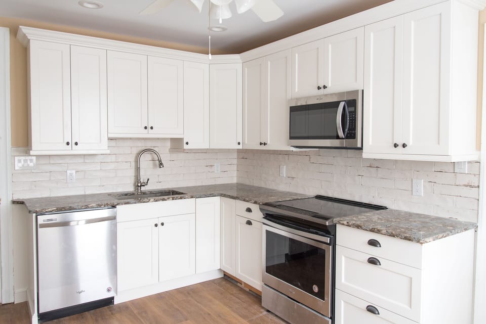 Updated kitchen - stainless steel dishwasher, range, microwave.