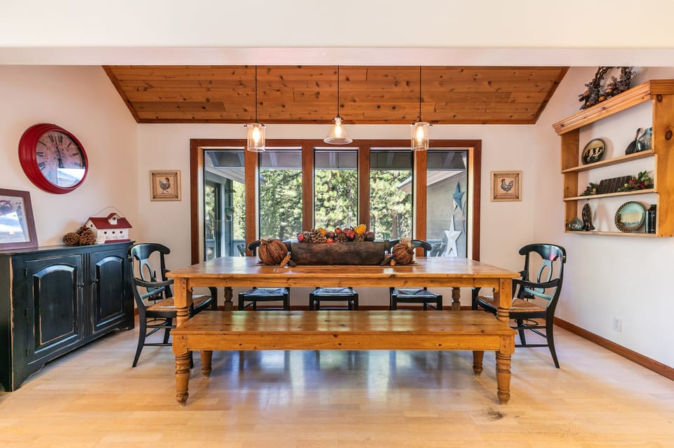 Dining area seats 8 guests with view to forest.