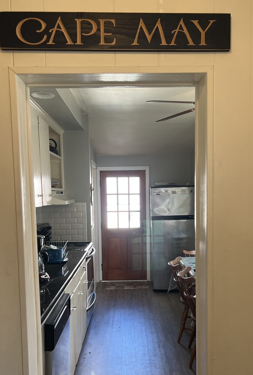Back exit to the yard, shower, grills, shed w/ beach equipment.