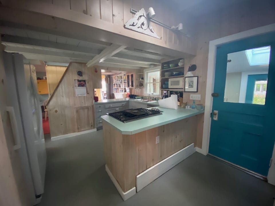 View from kitchen into middle room and living room beyond.