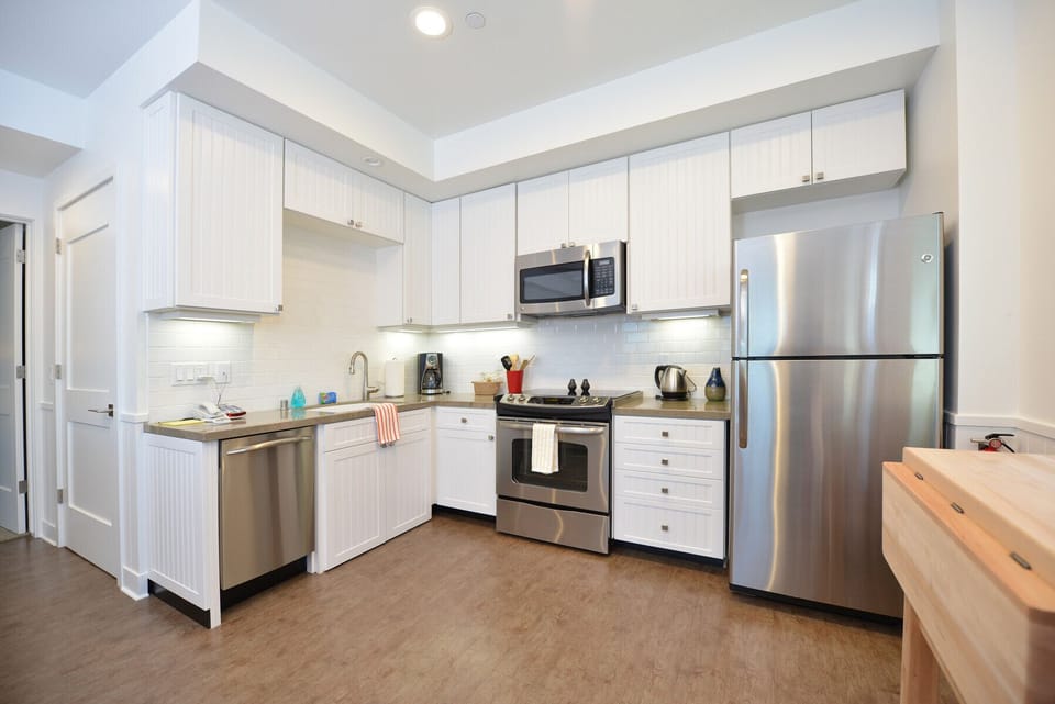 The kitchen has a full size refrigerator and stove and is stocked with everything you need to cook at home.