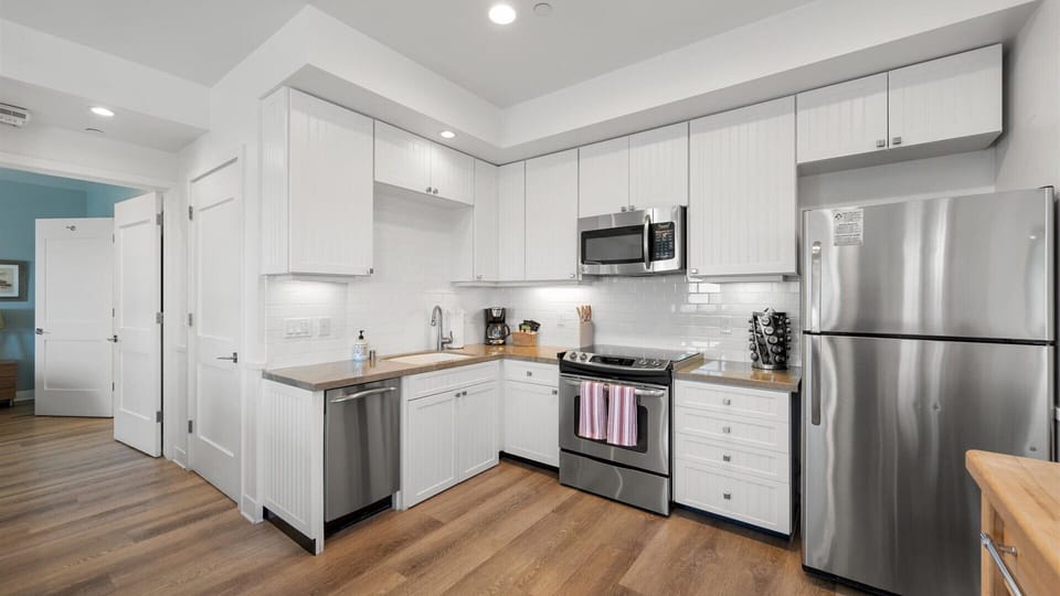 The kitchen has a full size refrigerator and stove and is stocked with everything you need to cook at home.