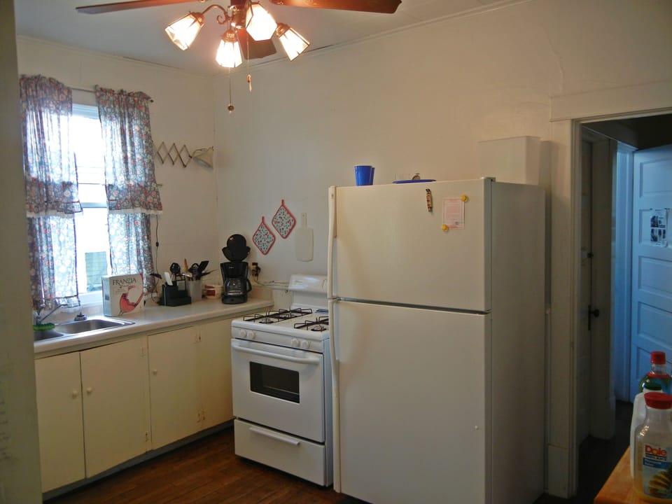 Kitchen joins pantry, has  back door.    Has no disposal or dish washer.