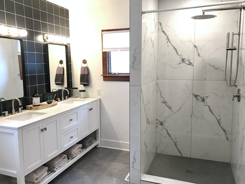En-suite bath features rain shower. Bath accessible from bedroom & hallway.