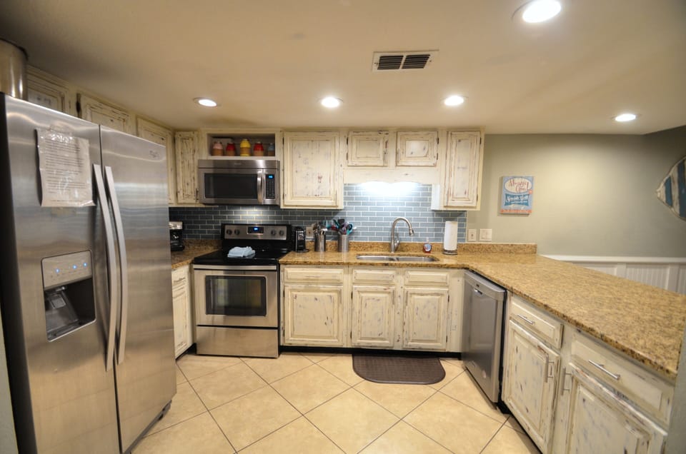 Fully equipped kitchen looking out towards the family room.  
