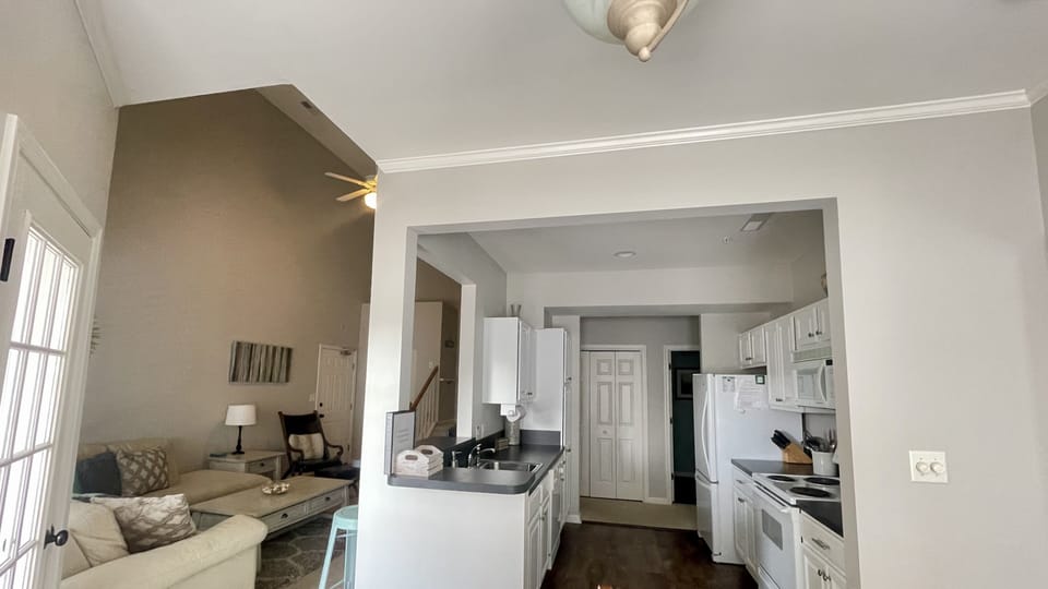 Bright white kitchen with eat in counter space for two