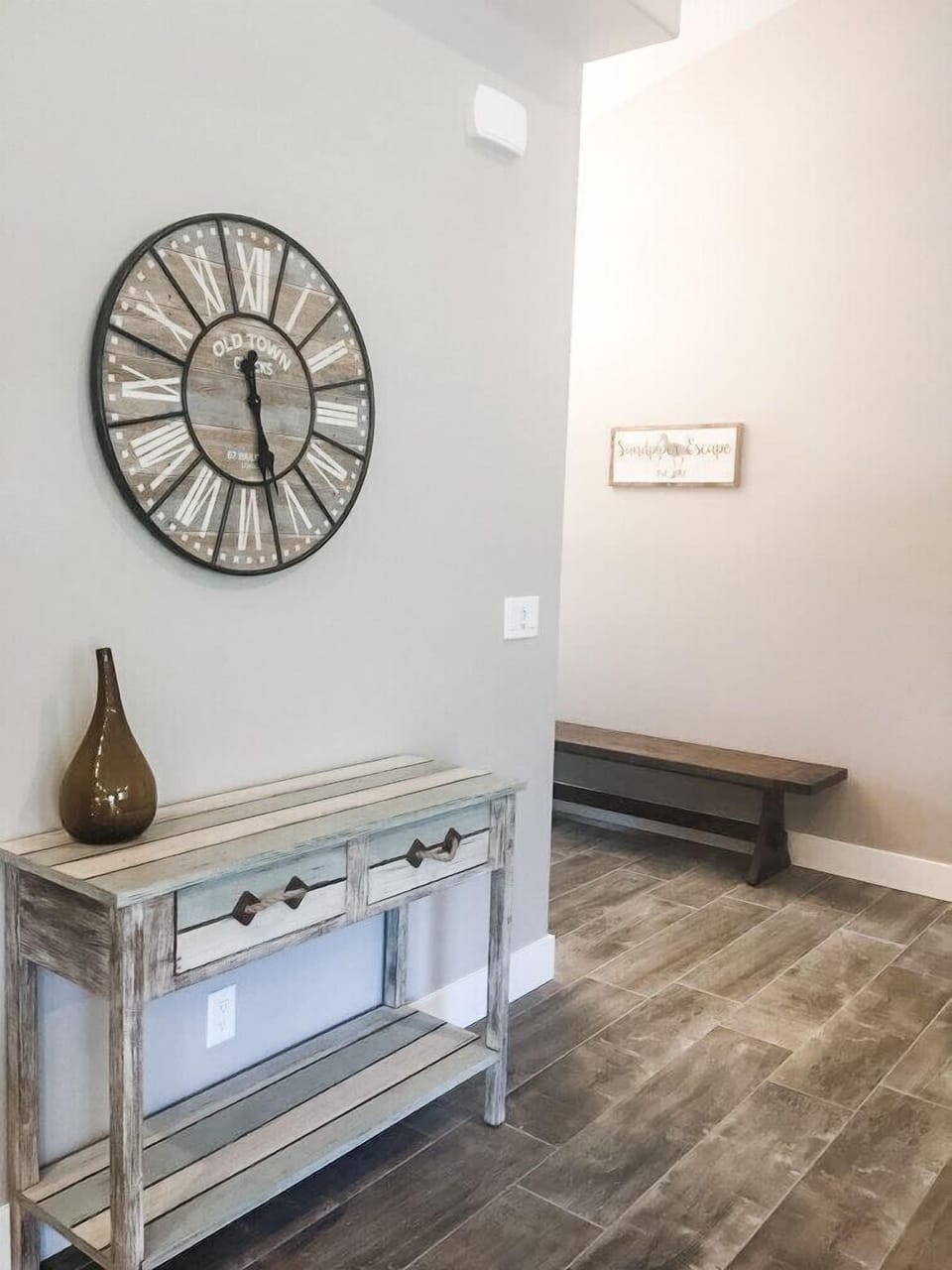 Entry includes coat hooks, a place to leave shoes, and a bench.