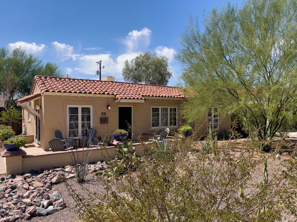 View from the sidewalk to the front of The Wilshire House and the natural Arizona vegetation.