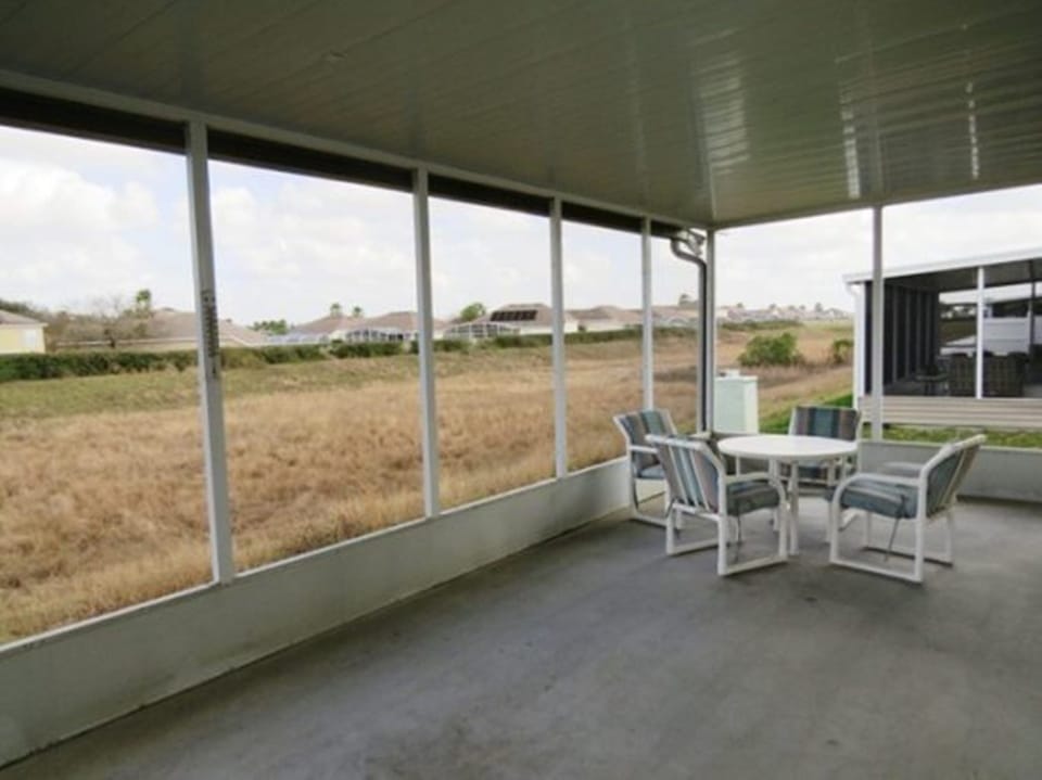 very private screen lanai with dining table and chairs