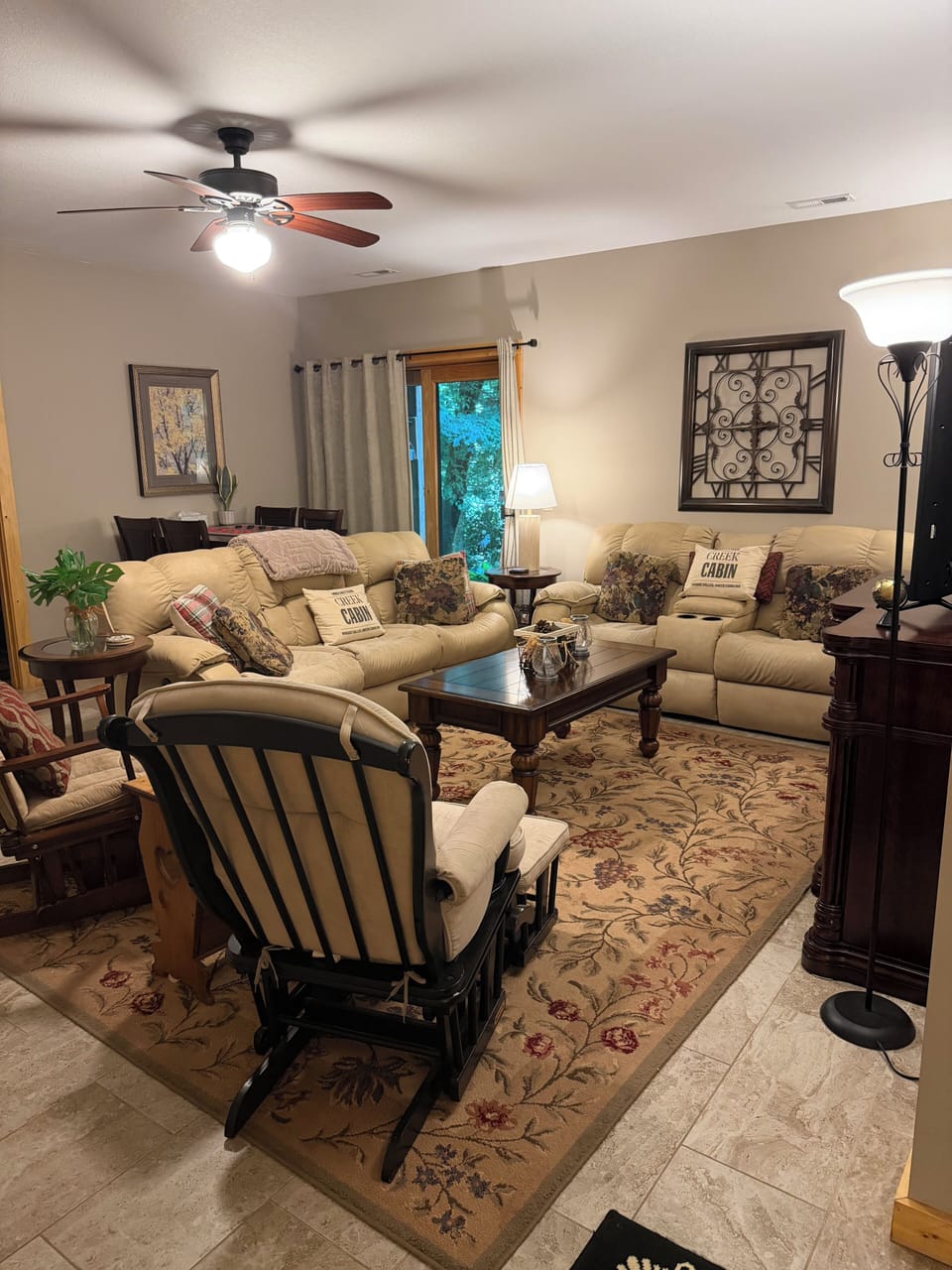 Lower level living room, electric recliners, TV, bar, fridge, wine cooler. 