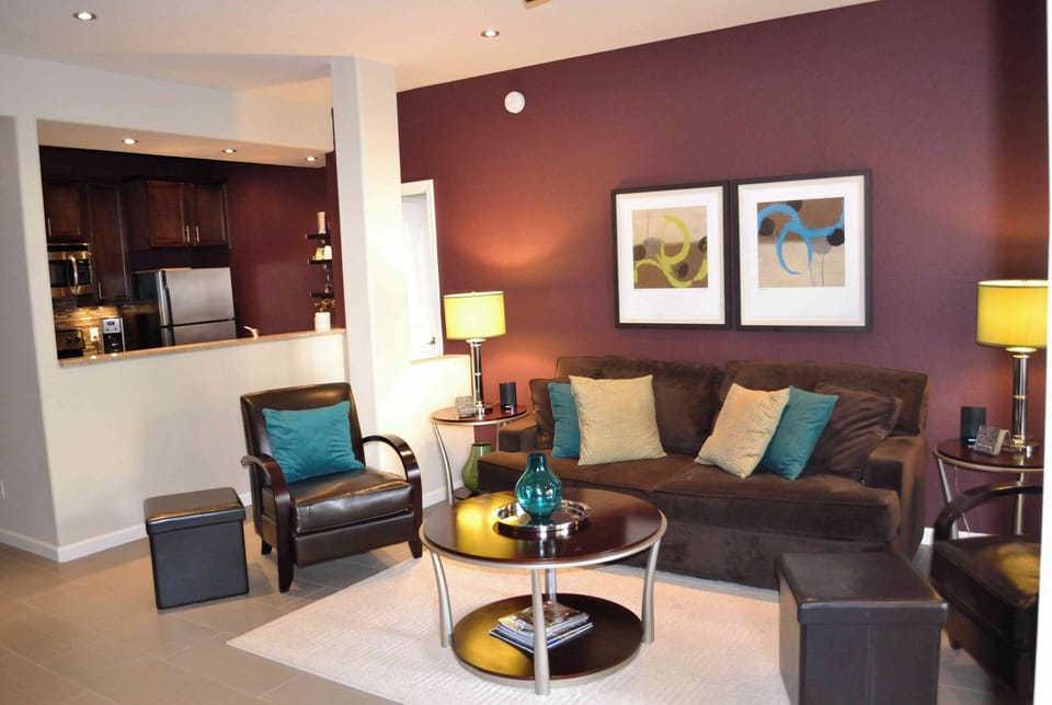 Bright, spacious living room with georgeous lighting and ceiling fan