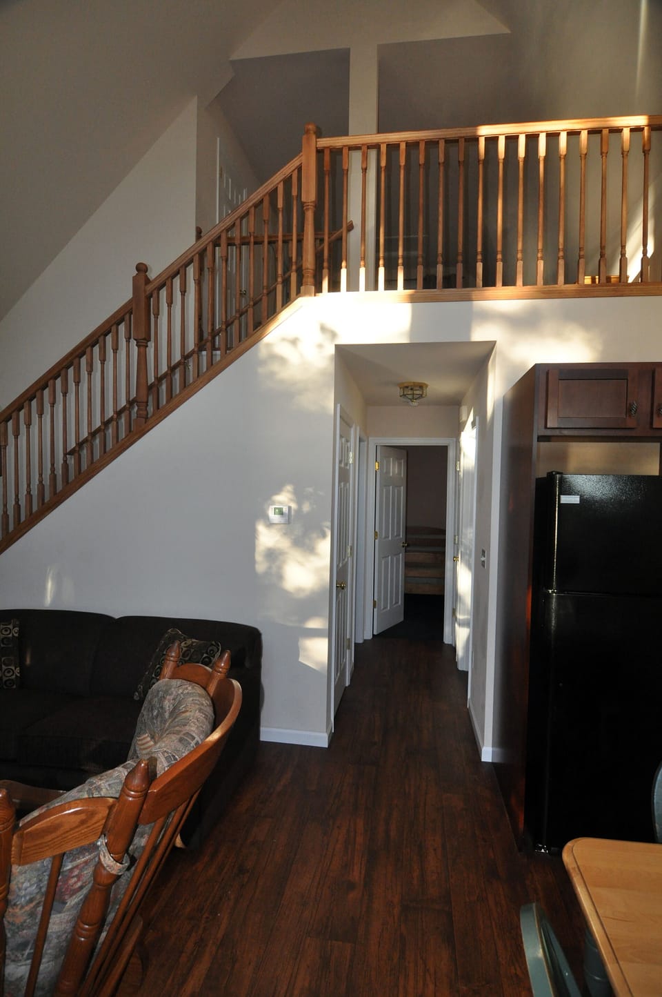 Hallway leading to 2 downstairs bedrooms and view to upstairs loft area.