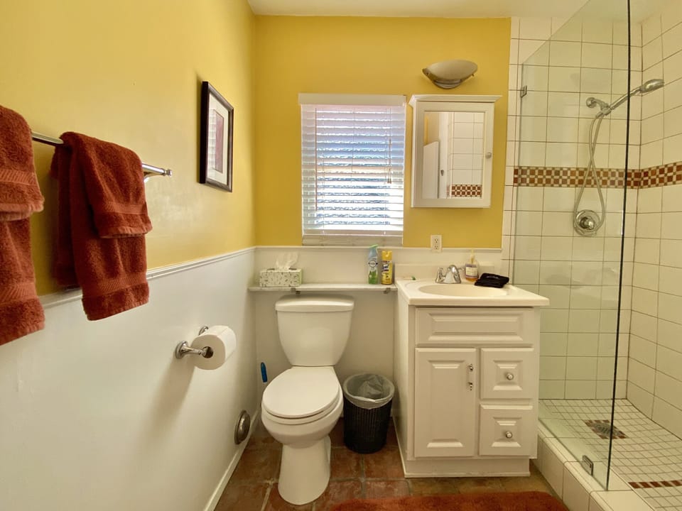 bathroom with full size shower and amenities
