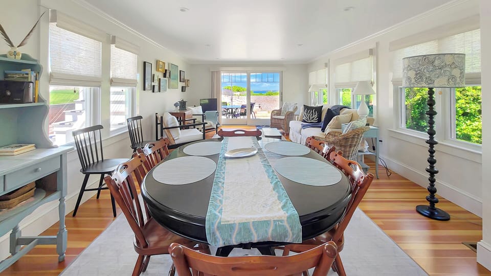 Large dining table with family room beyond
