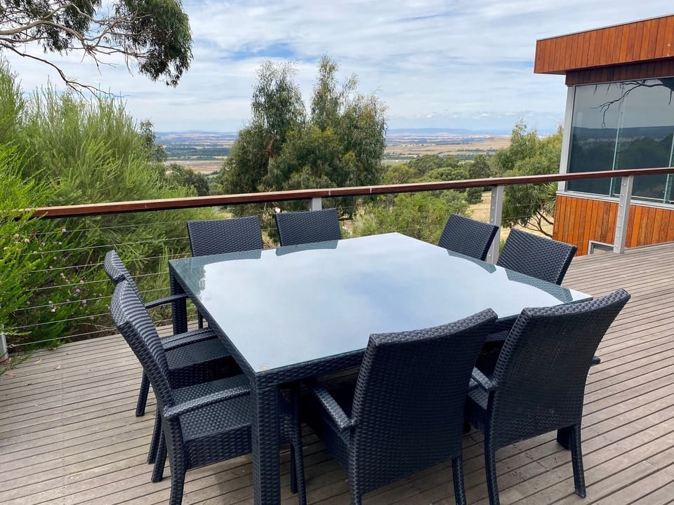 Outdoor dining table on north facing deck with BBQ