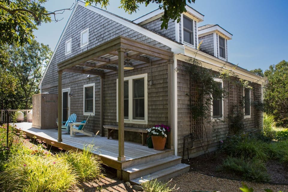Outside, leads to wraparound deck with dining and lounge seating and backyard 