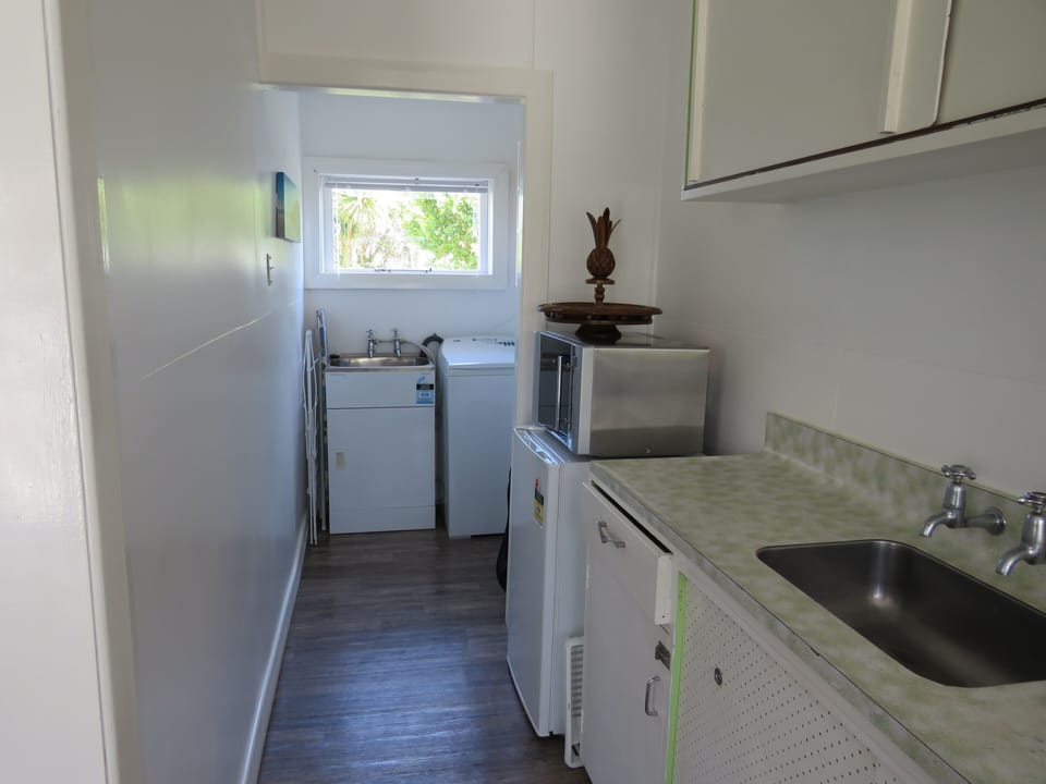 Kitchen to laundry.  Now has a fridge freezer.