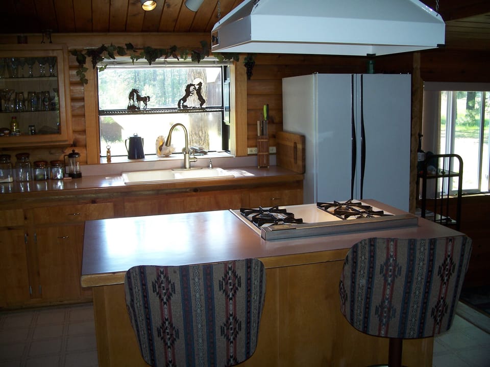 The Kitchen , complete with cookware utensils, microwave, coffee maker, blender.