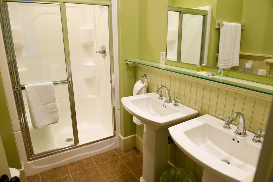 Ensuite bathrooms in all bedrooms featuring dual pedestal sinks and large shower