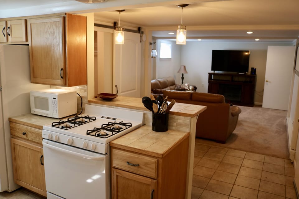 Kitchen & bar with high end lighting all on dimmers. Open to living room.