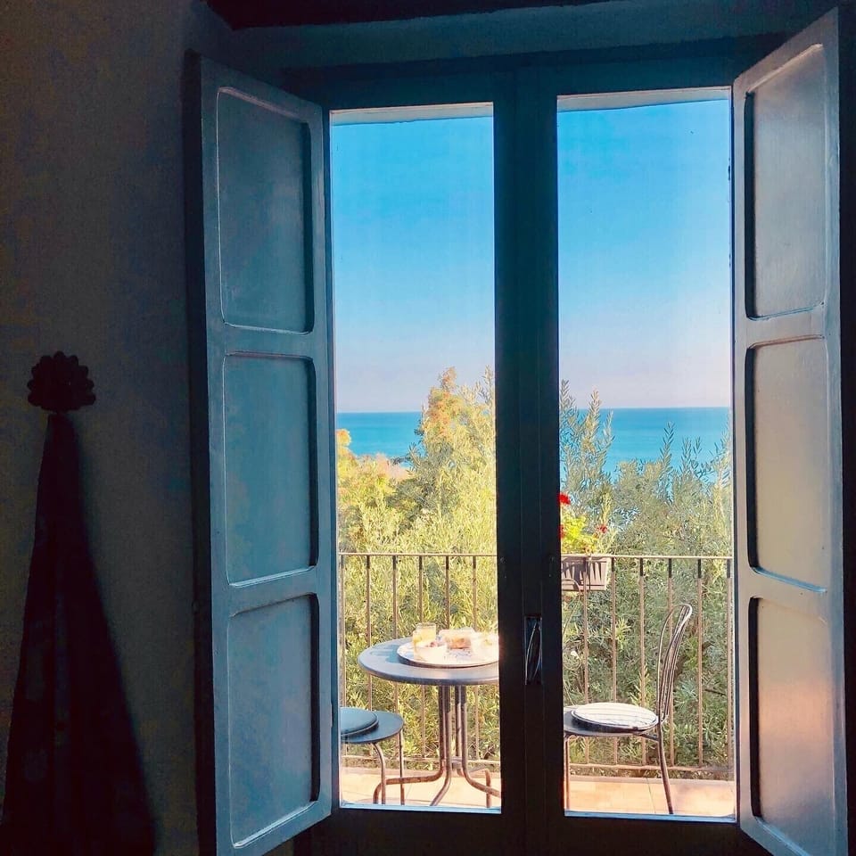Shutters lead out to balcony with sea views 