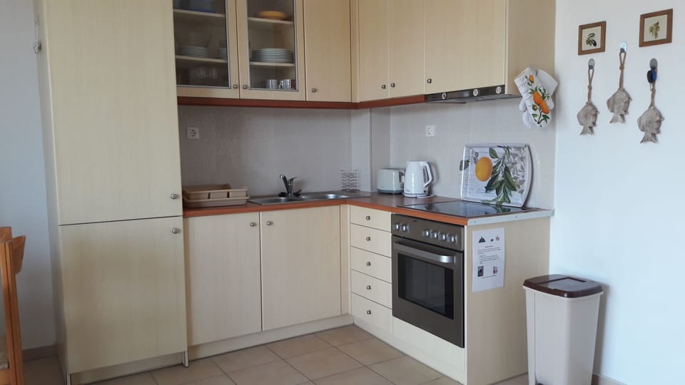 Kitchen has fridge/freezer and oven with hob