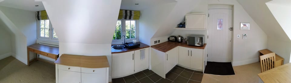 Panorama of kitchen and desk