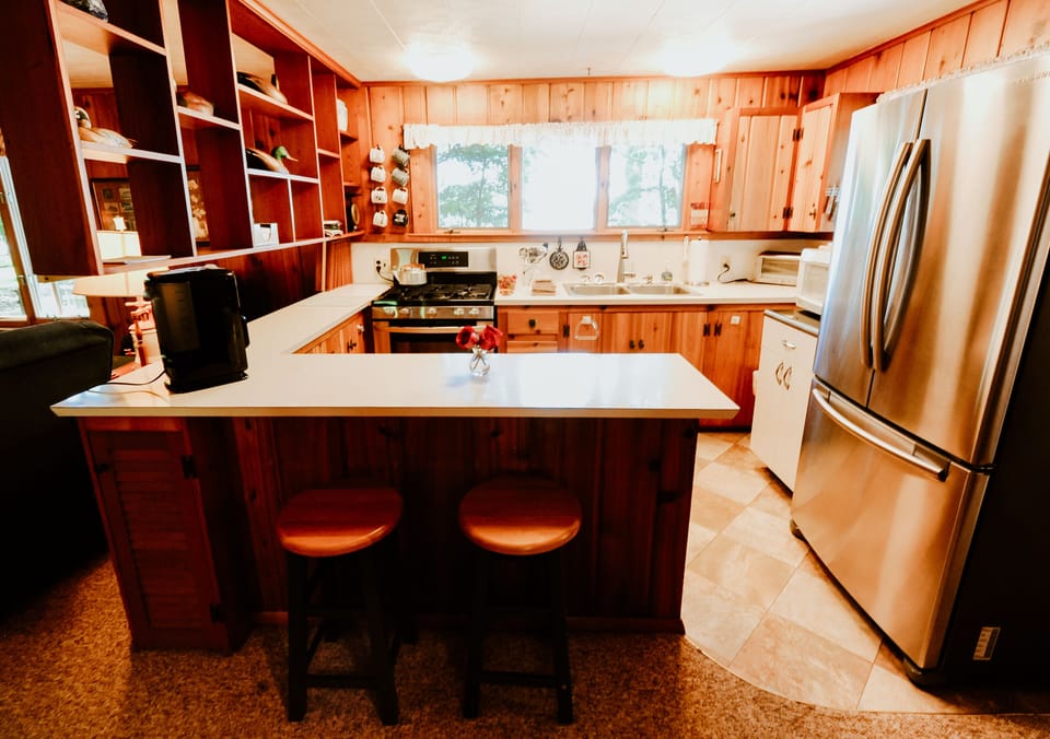Efficient kitchen with new stainless steel appliances.