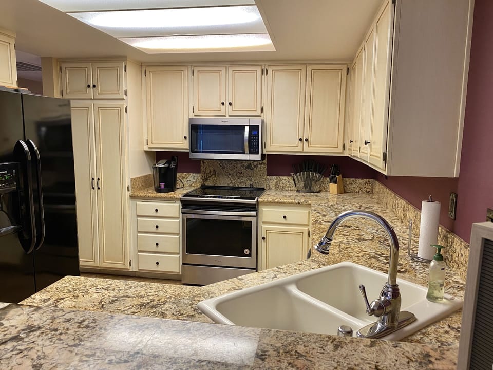 Full granite slab counters, custom glazed cabinets & new appliances