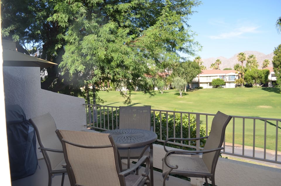 Patio seating and gas BBQ overlooking the tee box of the 5th hole