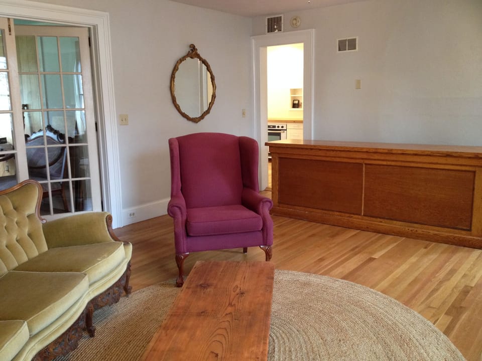 Spacious parlor (one of two) that adjoins kitchen, with a cozy gas fireplace.