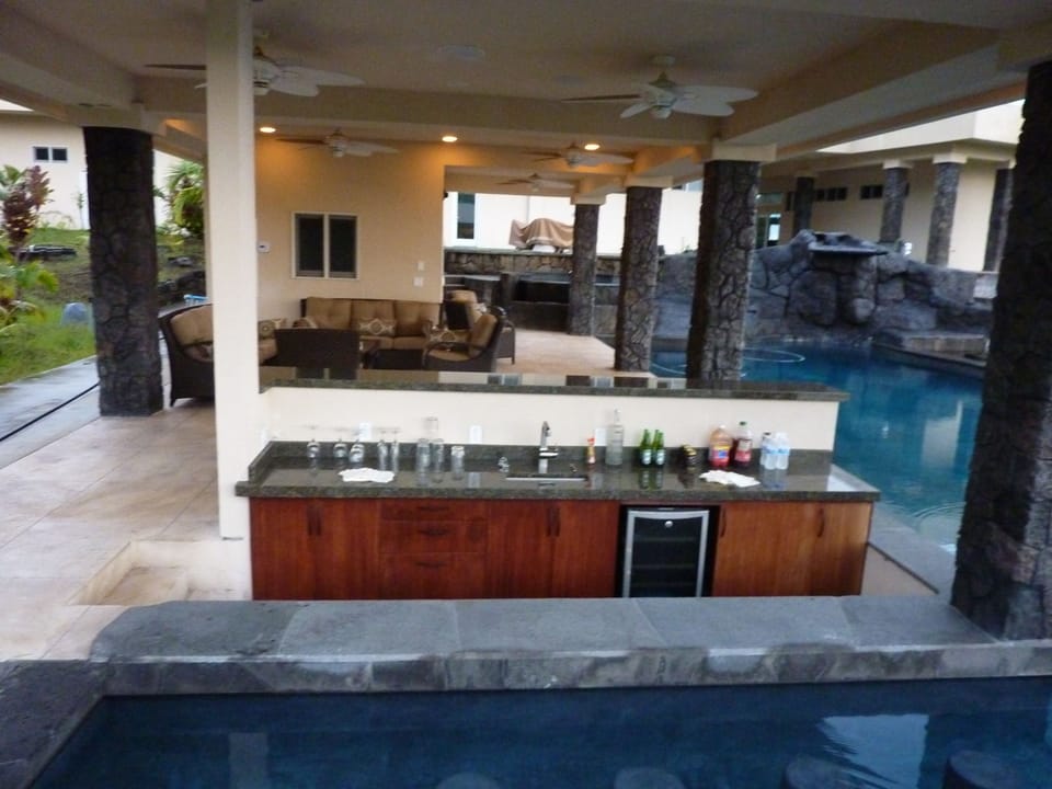 Pool house, lanai, dry pool bar, and swim-up wet pool bar