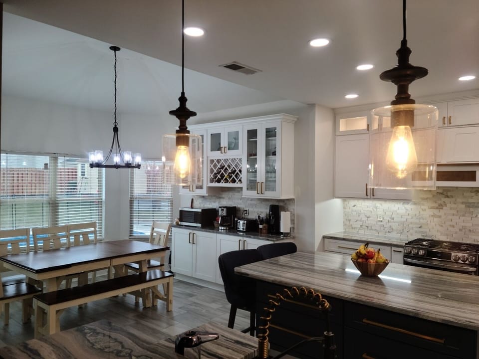 Newly renovated kitchen with seating for 8 at table, 2 at island, and 3 at bar.