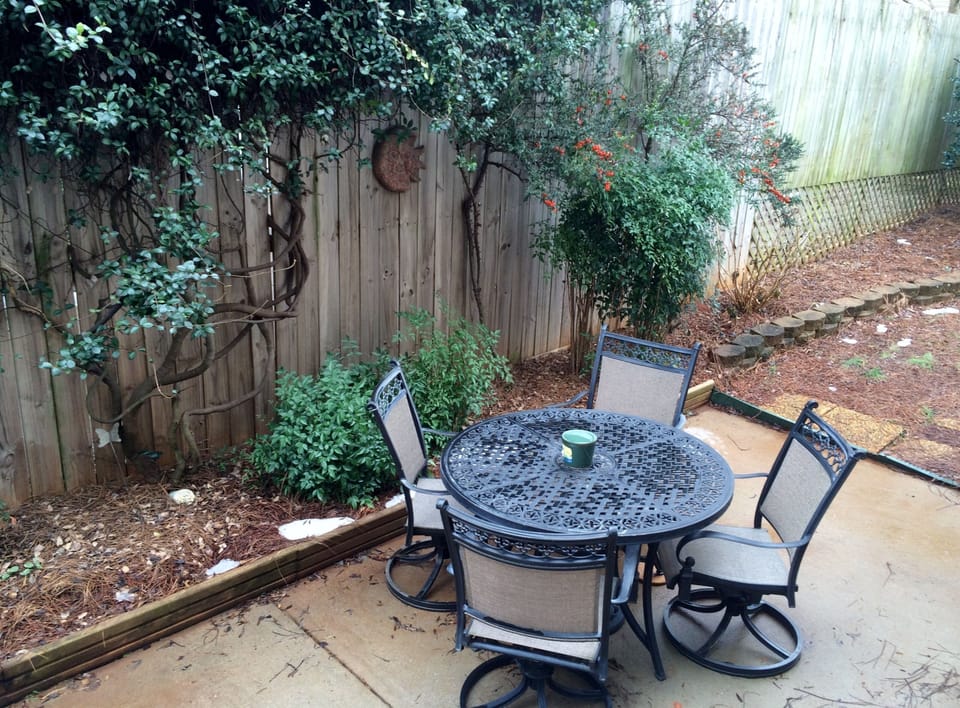Back patio, with patio table, 4 rocking chairs, and 2 extra fixed chairs