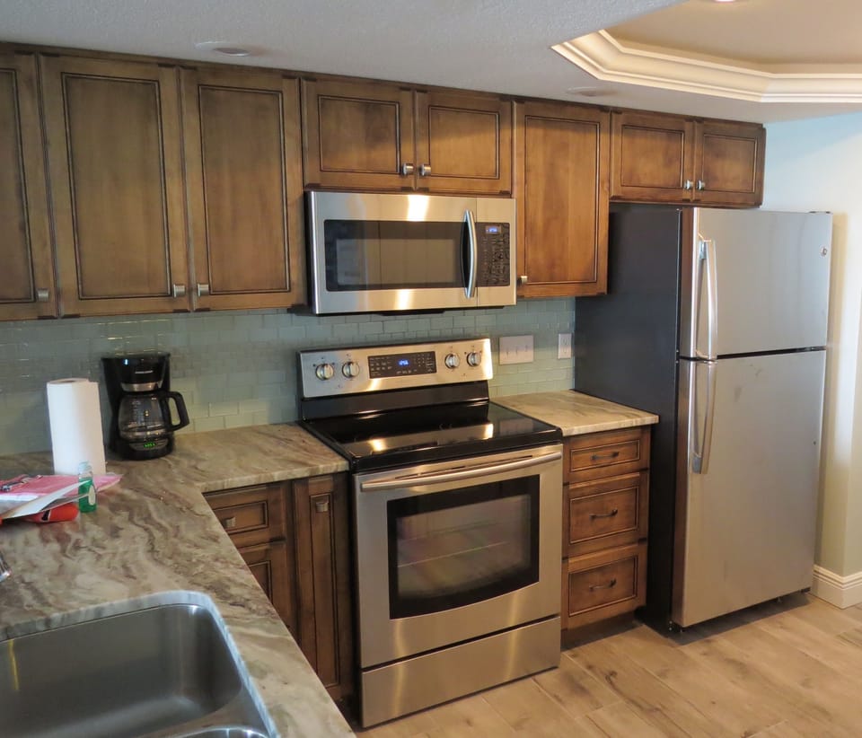 Kitchen with tray ceiling, indirect lighting and toe-kick lighting. 