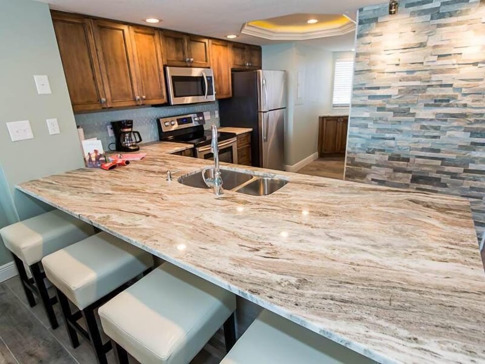 Kitchen with Amish-made cabinetry and new stainless steel appliances.