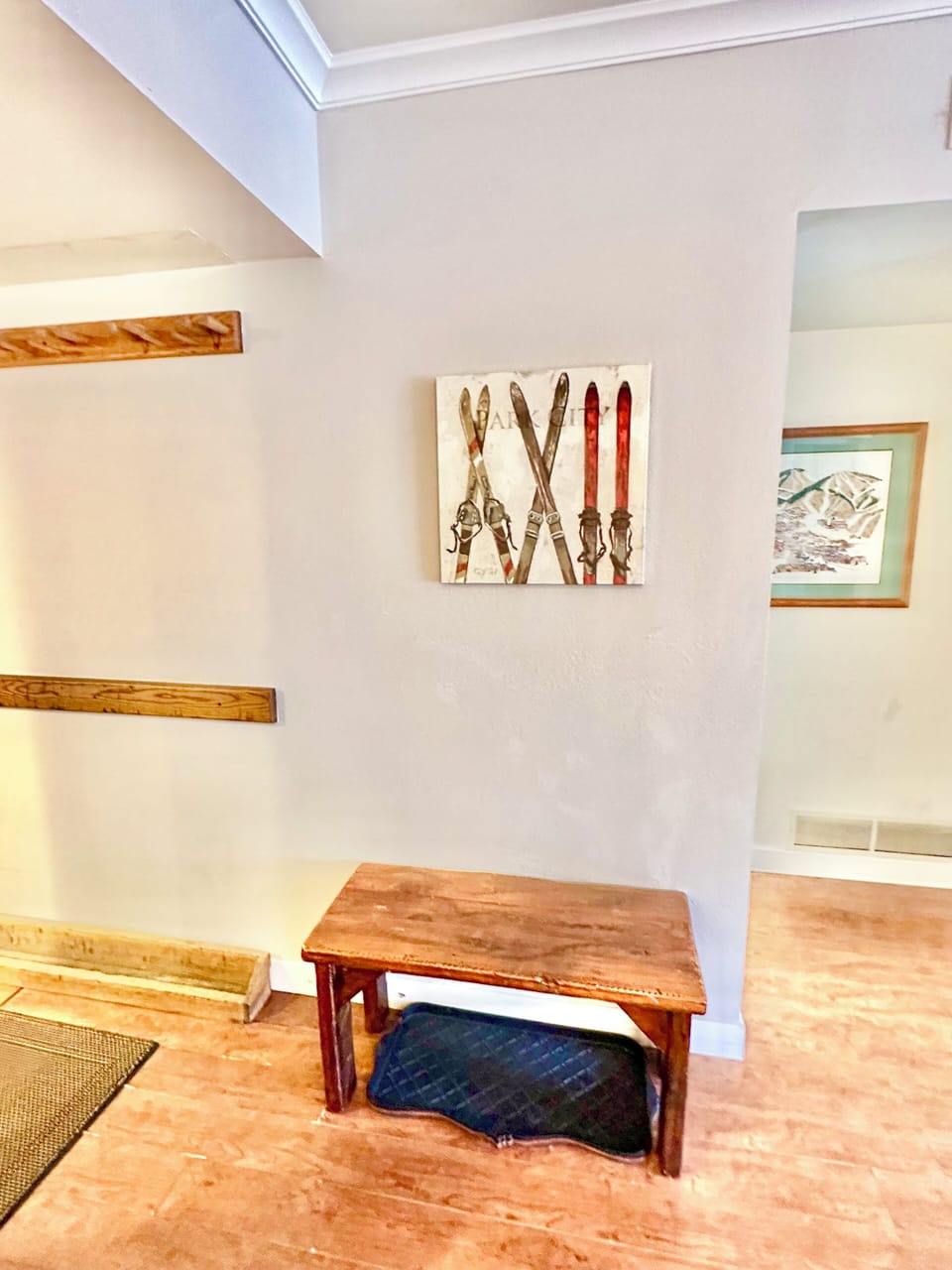 Condo entrance bench to put on boots and hang your skis & poles on the ski rack.